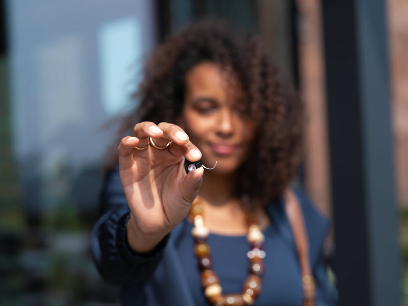 Oticon Zeal hearing aid in hand