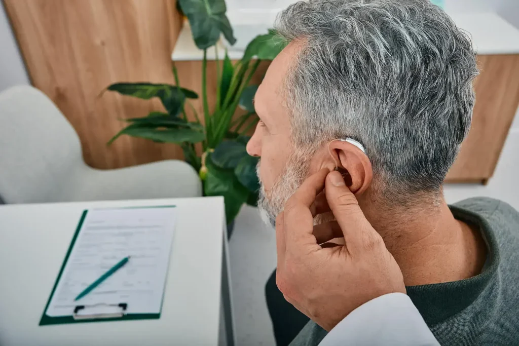 Audiologist fits hearing aid for low frequency hearing loss